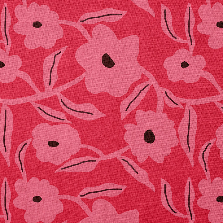 Floral patterned cotton fabric with pink flowers on a red background
