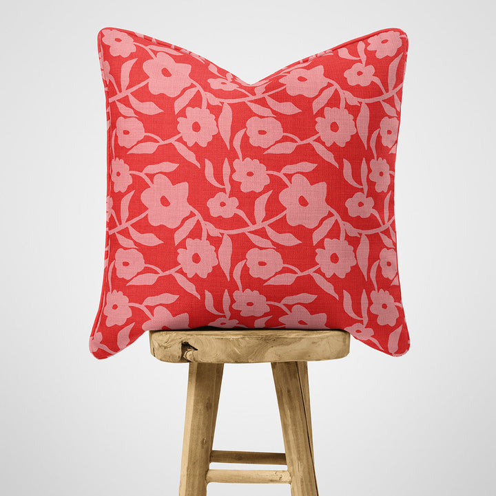 Red and pink floral cotton cushion on stool