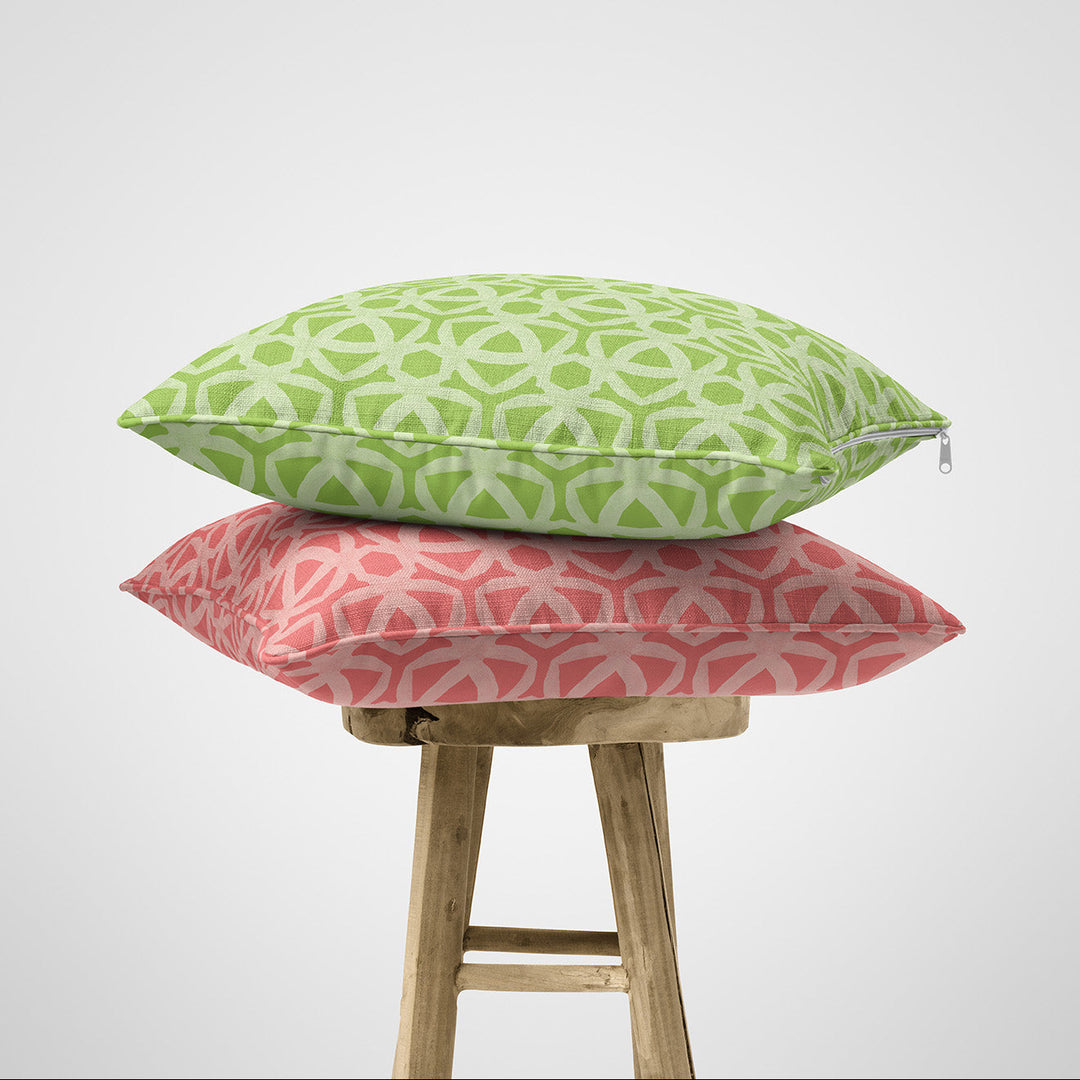 Green and pink geometric cotton cushions on wooden stool
